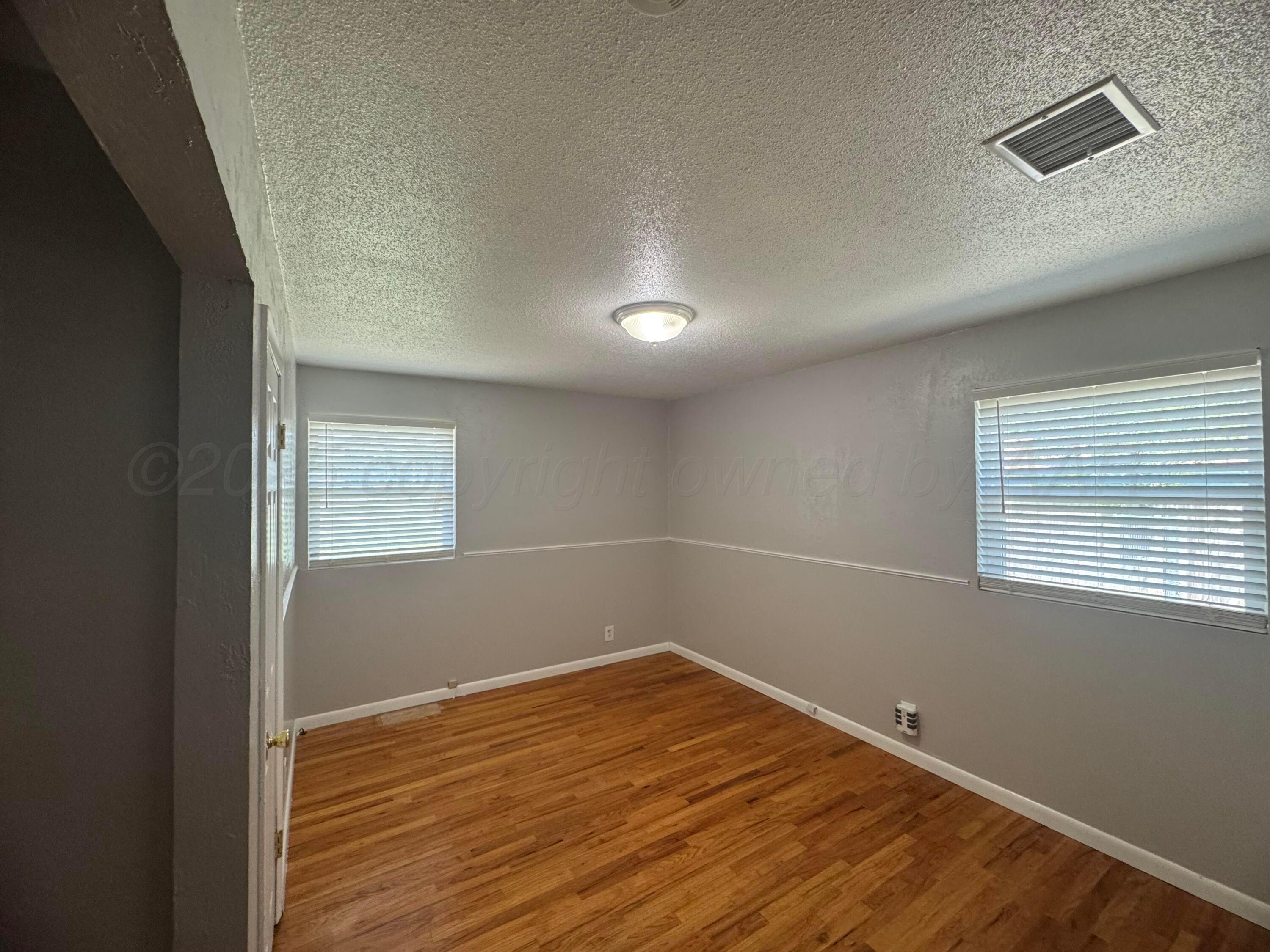 5112 Arden Road Amarillo, TX 79110 - Photo 21 of 28 a view of empty room with wooden floor and fan
