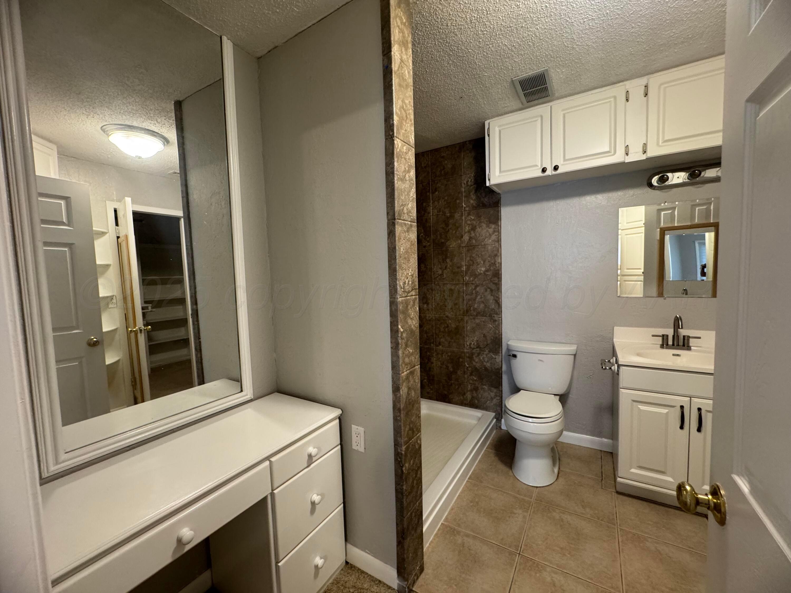 5112 Arden Road Amarillo, TX 79110 - Photo 25 of 28 a bathroom with a sink toilet and shower
