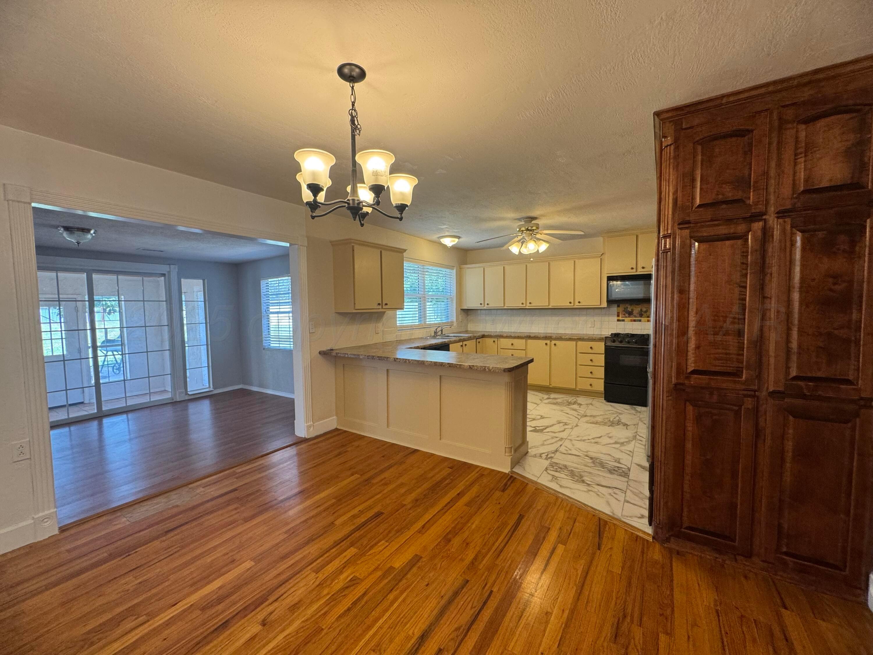 5112 Arden Road Amarillo, TX 79110 - Photo 4 of 28 a view of a kitchen with stove and wooden floor