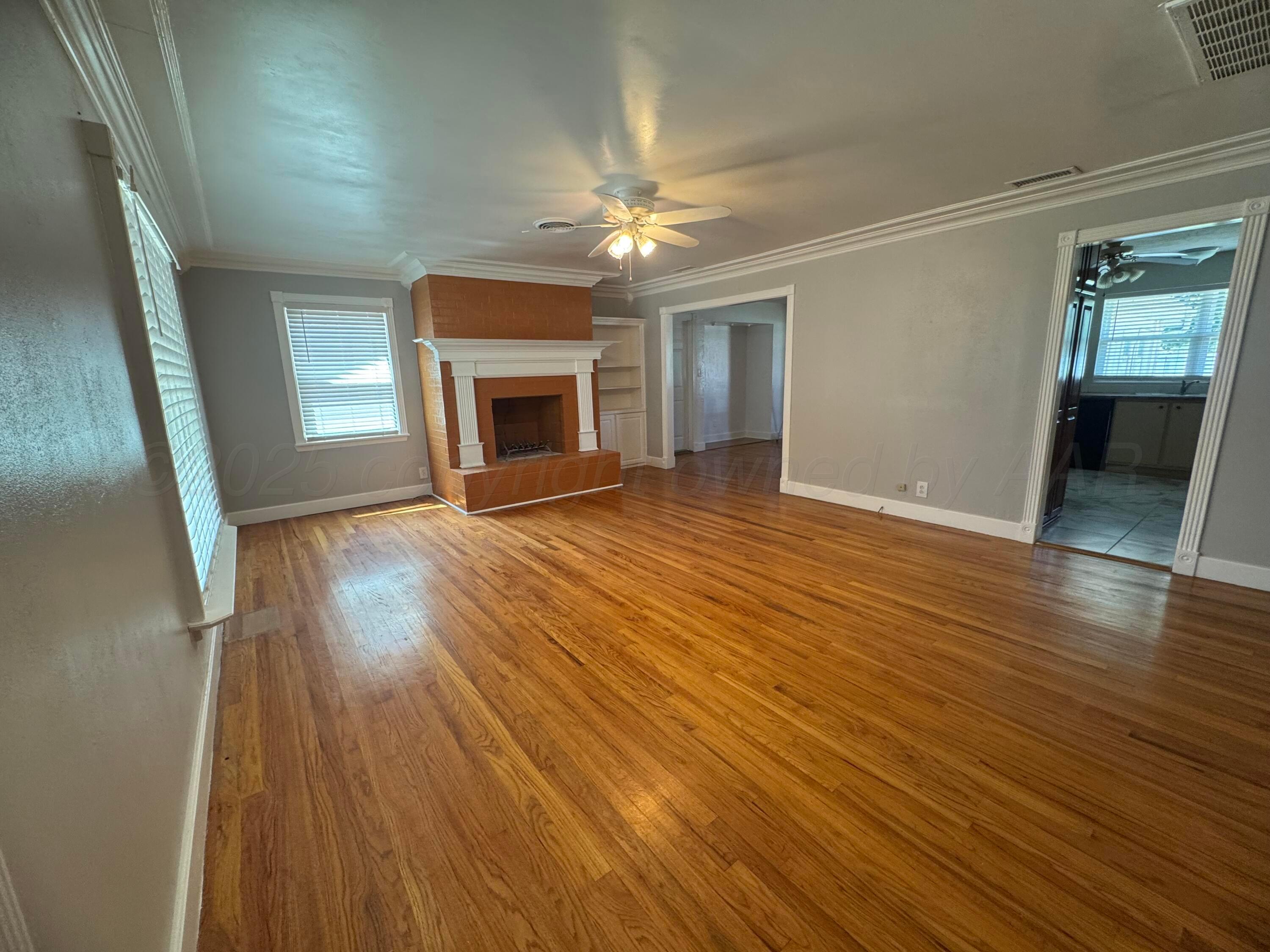 5112 Arden Road Amarillo, TX 79110 - Photo 9 of 28 wooden floor in an empty room with a window