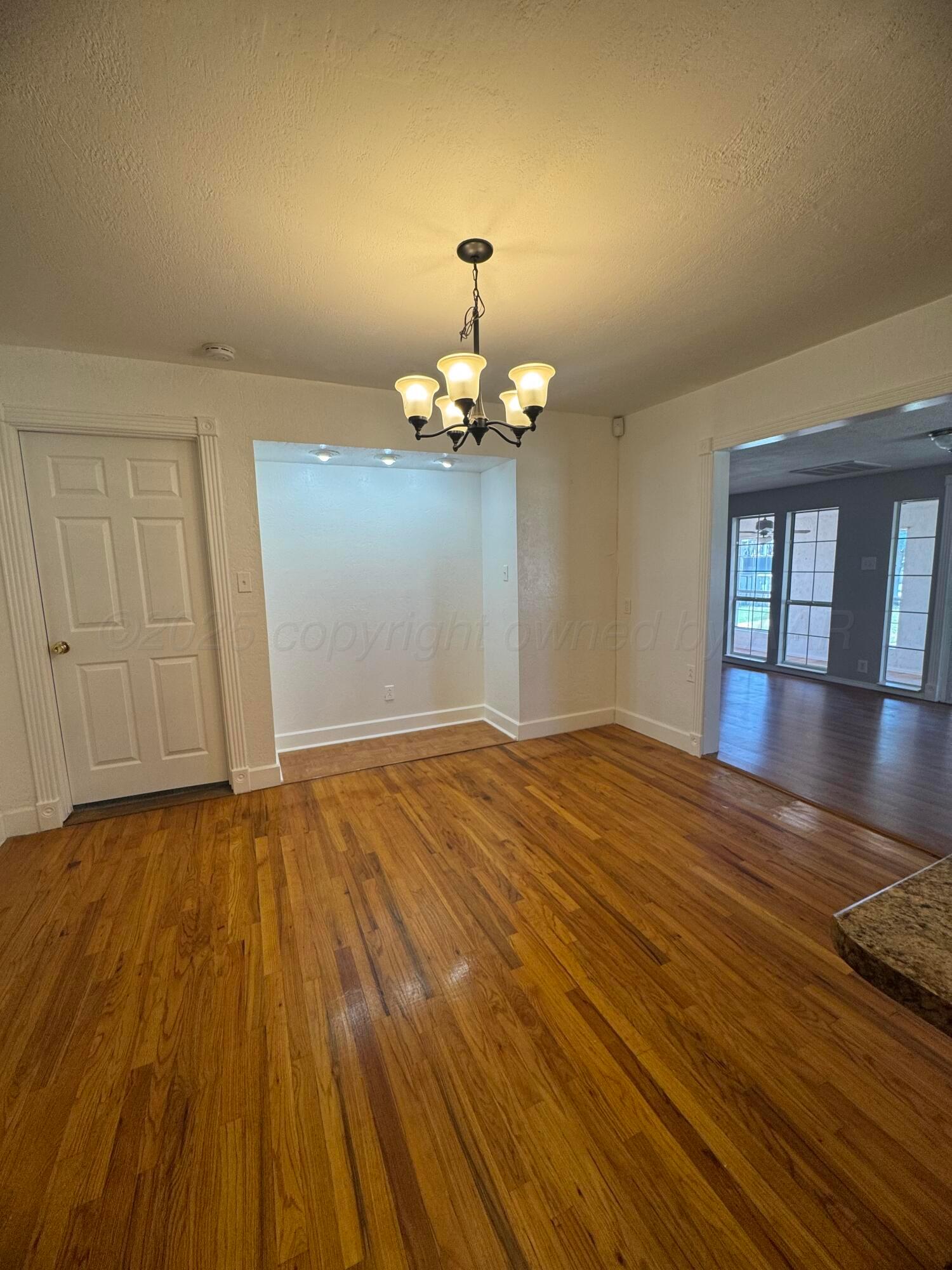 5112 Arden Road Amarillo, TX 79110 - Photo 10 of 28 a view of empty room with wooden floor