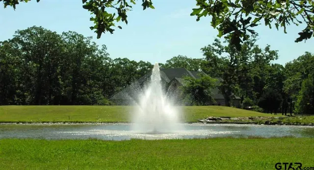 a view of yard with seating area and trees around