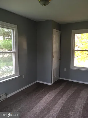 a view of a livingroom with an empty space and window
