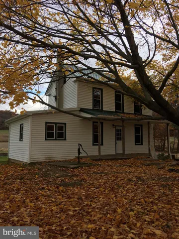 a house that has a tree in front of the house