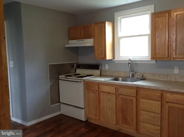 a kitchen with a sink cabinets and window