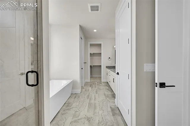a view of a bathroom with a tub and shower