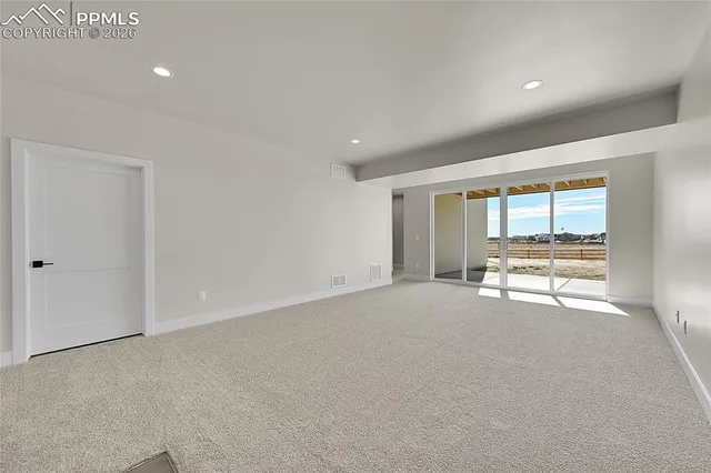 a view of an empty room with a fireplace