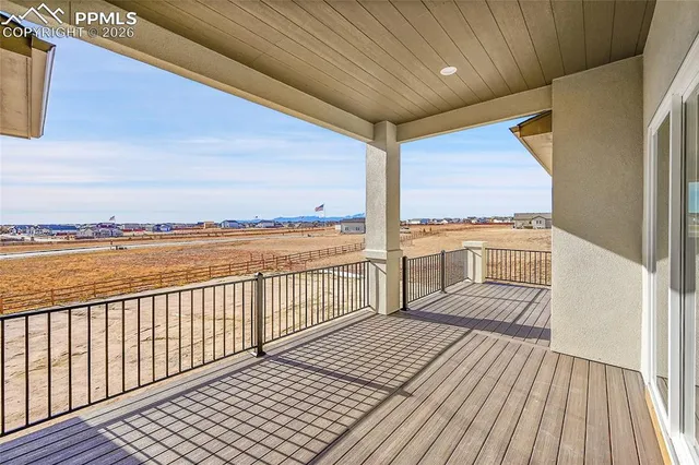 a view of a balcony with wooden floor