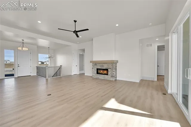 a view of empty room with wooden floor and fireplace