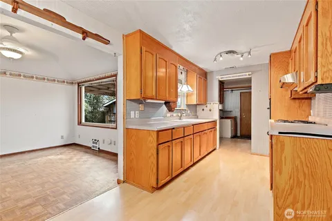 a kitchen with stainless steel appliances granite countertop a stove a sink and a refrigerator