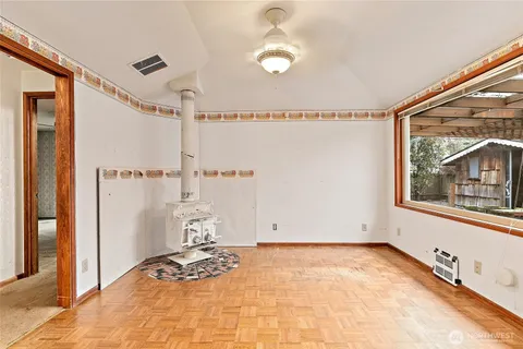 a view of a livingroom with wooden floor and window