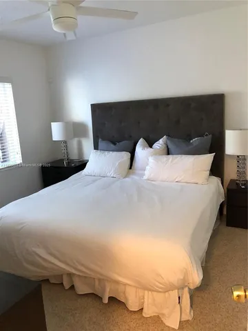 a bedroom with a bed and a lamp