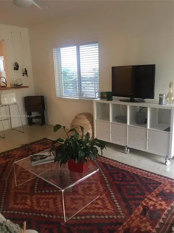 a room with wooden floor and flat screen tv