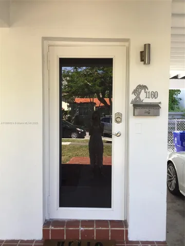 a view of a door and a window