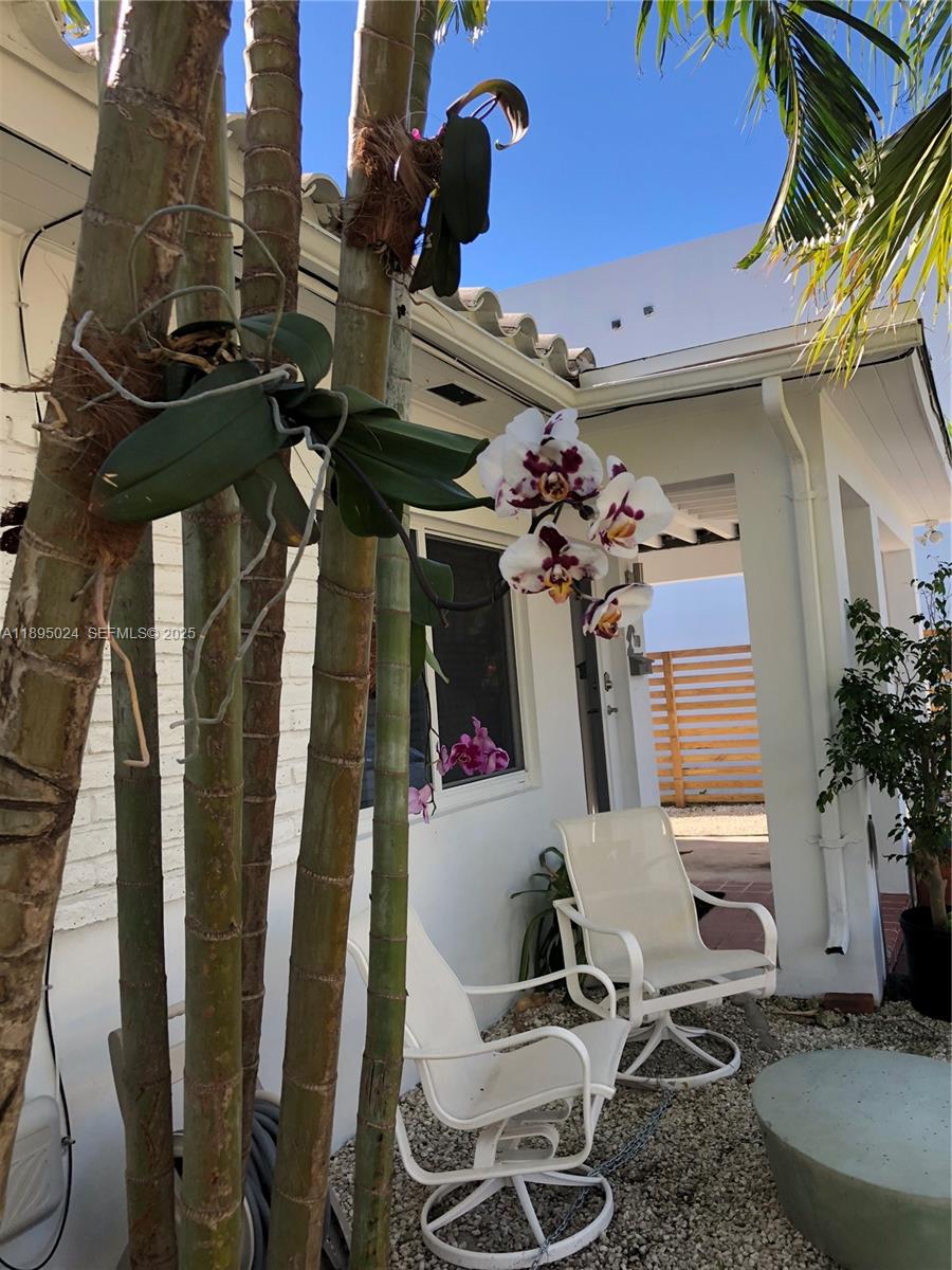 1160 Southwest 22nd Terrace, Unit 2 Miami, FL 33129 - Photo 27 of 29 a view of a patio with table and chairs with wooden floor