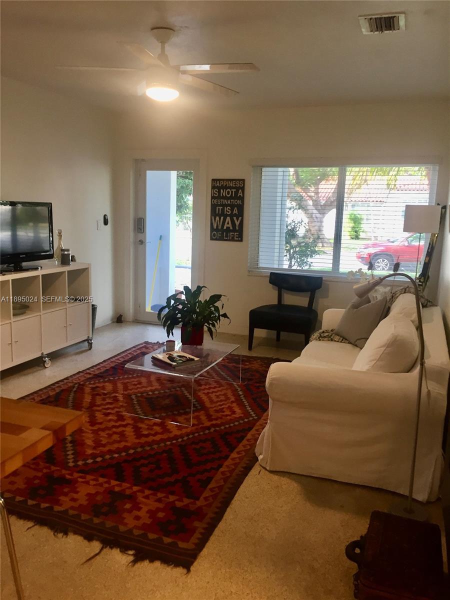 1160 Southwest 22nd Terrace, Unit 2 Miami, FL 33129 - Photo 3 of 29 a living room with furniture a large window and a flat screen tv