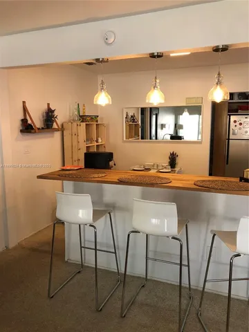 a kitchen with kitchen island a counter top space and a sink