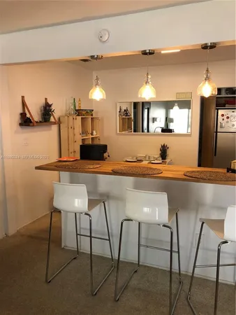 a kitchen with kitchen island a counter top space and a sink