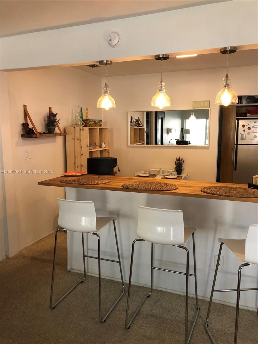 1160 Southwest 22nd Terrace, Unit 2 Miami, FL 33129 - Photo 4 of 29 a kitchen with kitchen island a counter top space and a sink