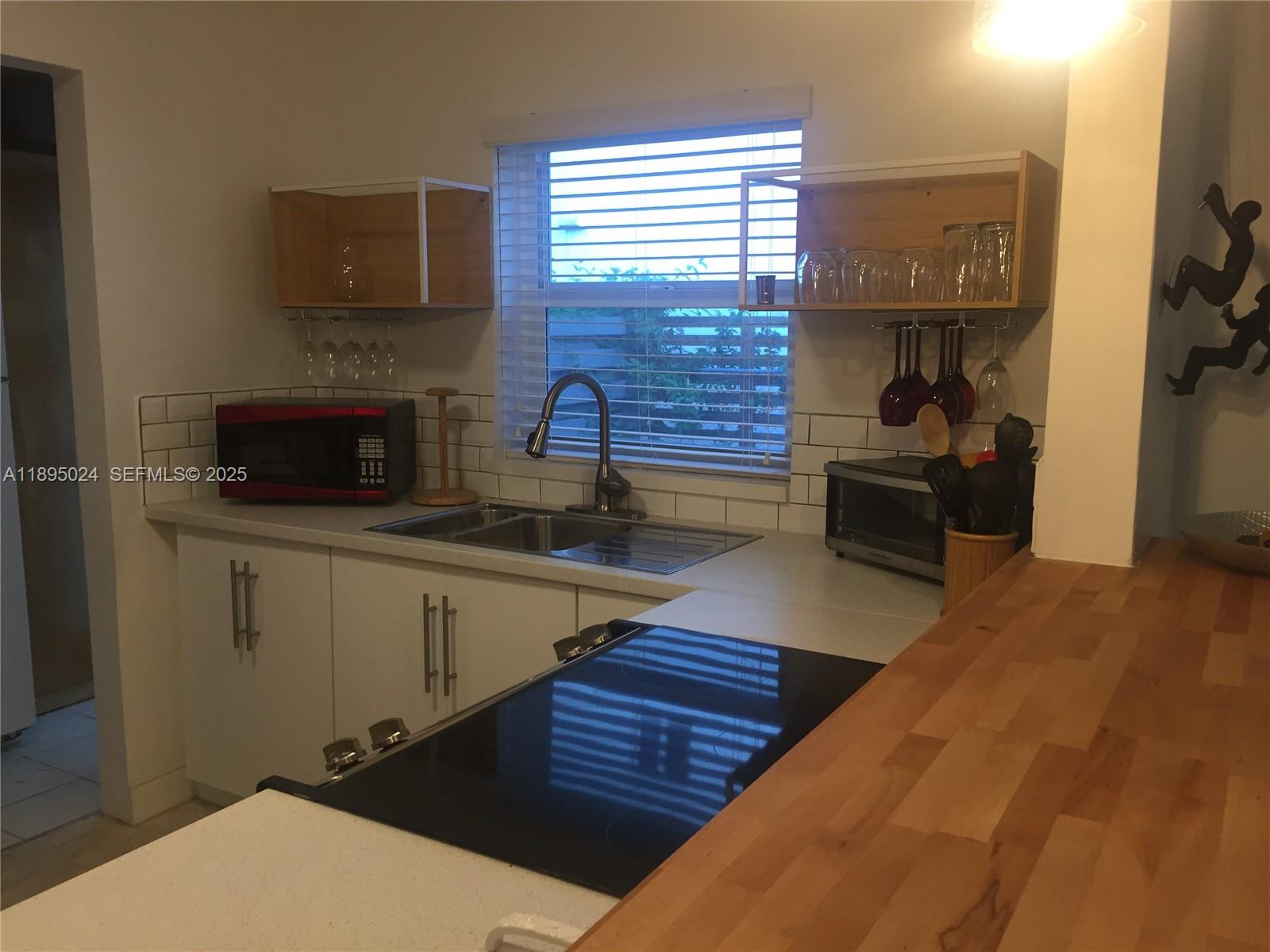 1160 Southwest 22nd Terrace, Unit 2 Miami, FL 33129 - Photo 8 of 29 a kitchen with sink and refrigerator