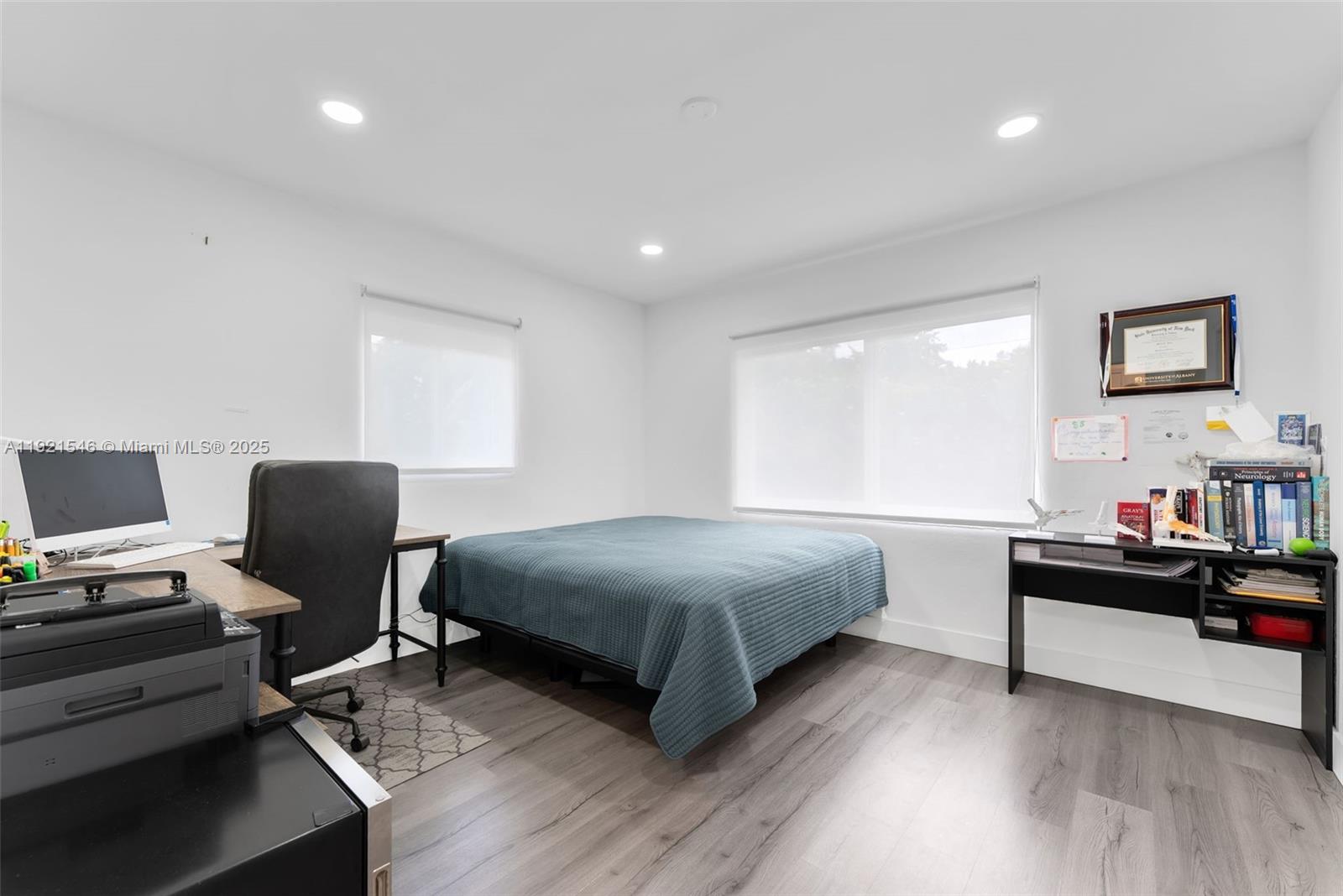 195 Northwest 115th Street Miami, FL 33168 - Photo 11 of 29 a bedroom with a bed and a computer on desk
