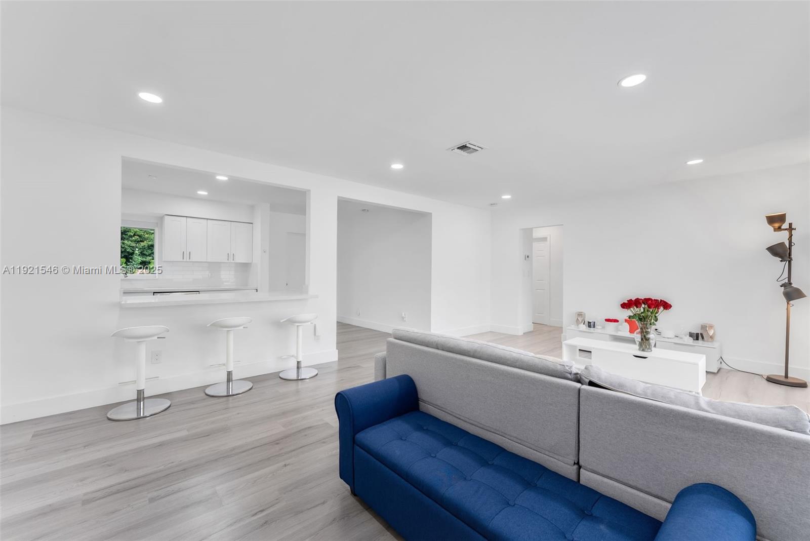 195 Northwest 115th Street Miami, FL 33168 - Photo 3 of 29 a living room with kitchen island furniture and a wooden floor