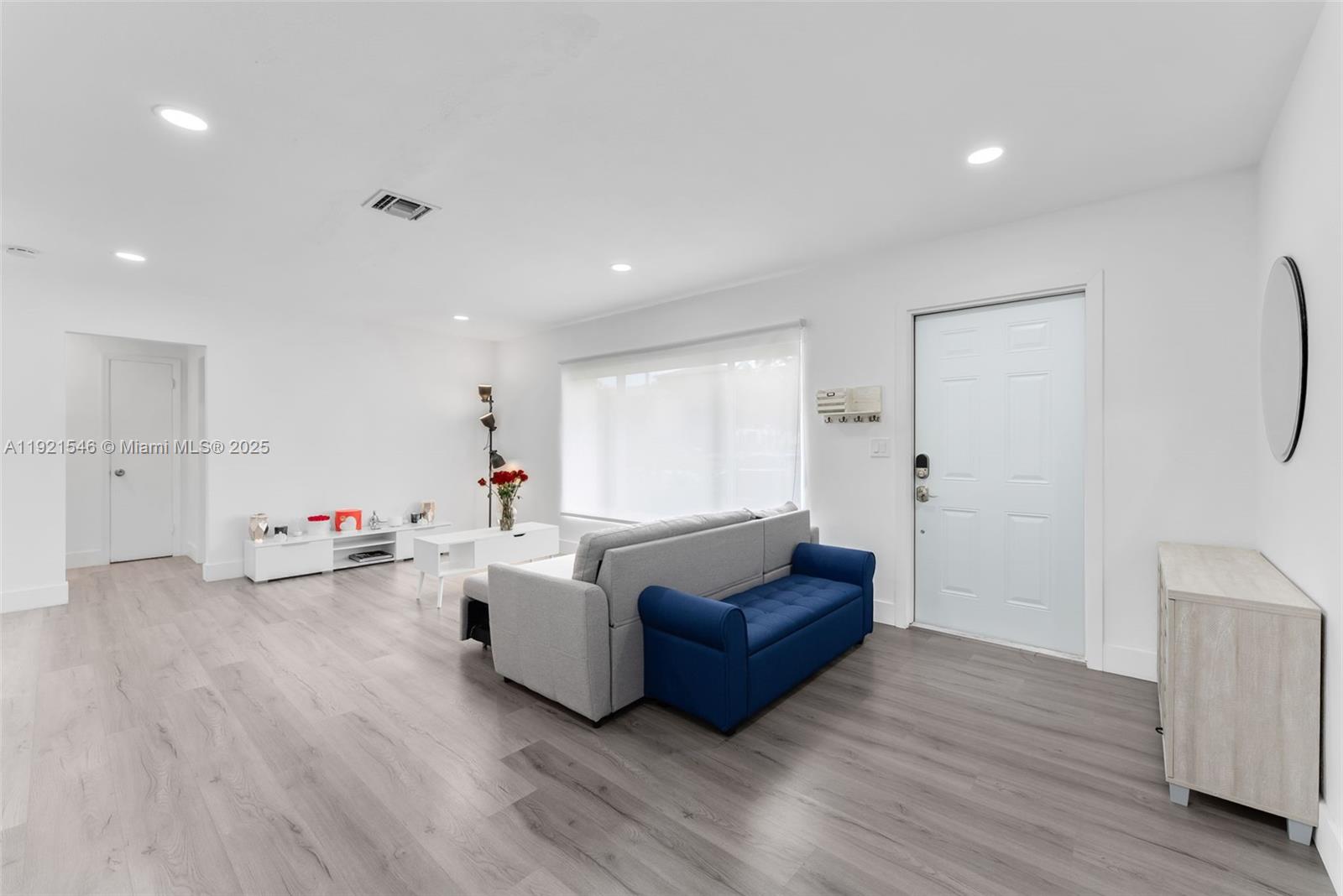 195 Northwest 115th Street Miami, FL 33168 - Photo 4 of 29 a living room with furniture and a wooden floor