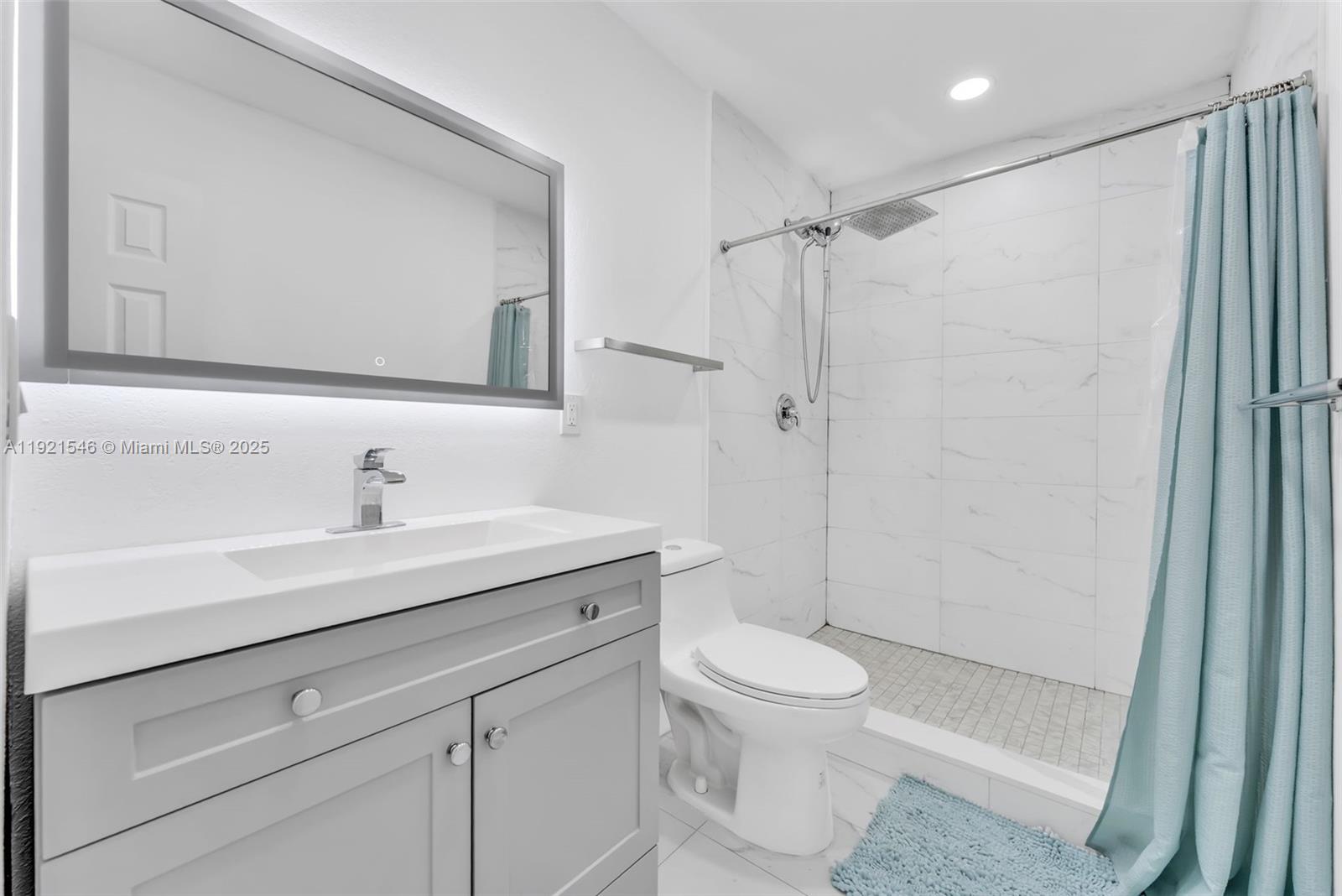 195 Northwest 115th Street Miami, FL 33168 - Photo 10 of 29 a bathroom with a shower sink vanity mirror and toilet