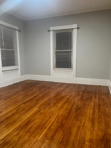 a view of wooden floor and brick walls