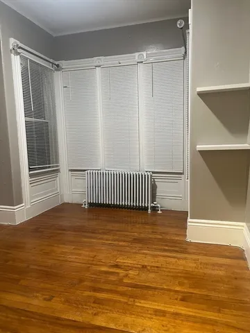 a view of a room with wooden floor