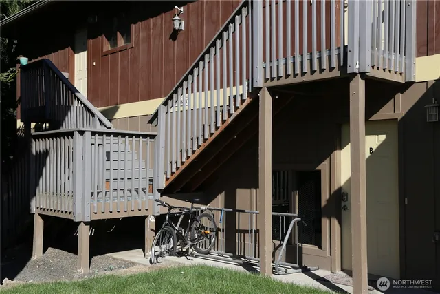 a view of entryway with wooden floor and stairs