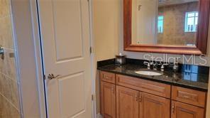 650 Golden Gate Point, Unit 301 Sarasota, FL 34236 - Photo 22 of 31 a bathroom with a sink and a mirror