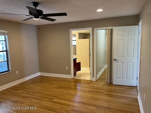a view of a livingroom with a ceiling fan and window