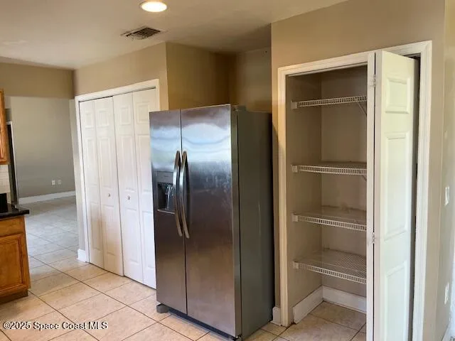 a view of a refrigerator in kitchen and wooden floor