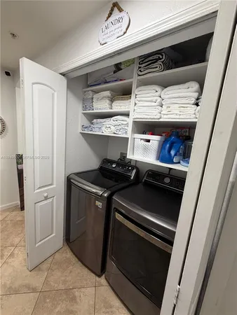 a view of a hallway with closet and mirror
