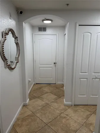 a bathroom with a granite countertop toilet sink and mirror