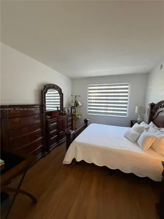 a view of a room that has a chair and table in it