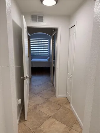 a view of a room that has a window and a door