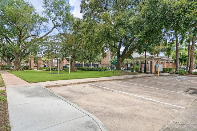a view of a house with a big yard and large trees