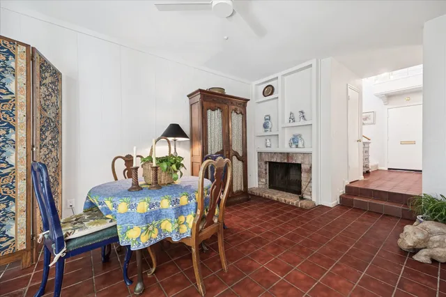 a dining room with furniture a rug and a fireplace