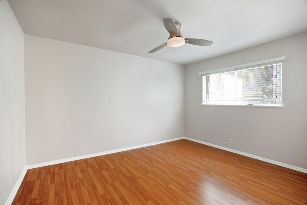 1311 Exposition Boulevard, Unit 8 Austin, TX 78703 - Photo 4 of 10 Empty room with light wood-style flooring and ceiling fan