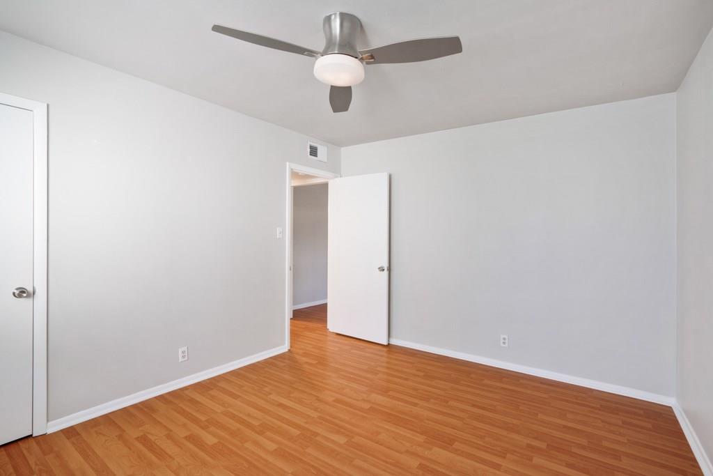 1311 Exposition Boulevard, Unit 8 Austin, TX 78703 - Photo 5 of 10 Unfurnished room featuring light wood-style flooring and ceiling fan