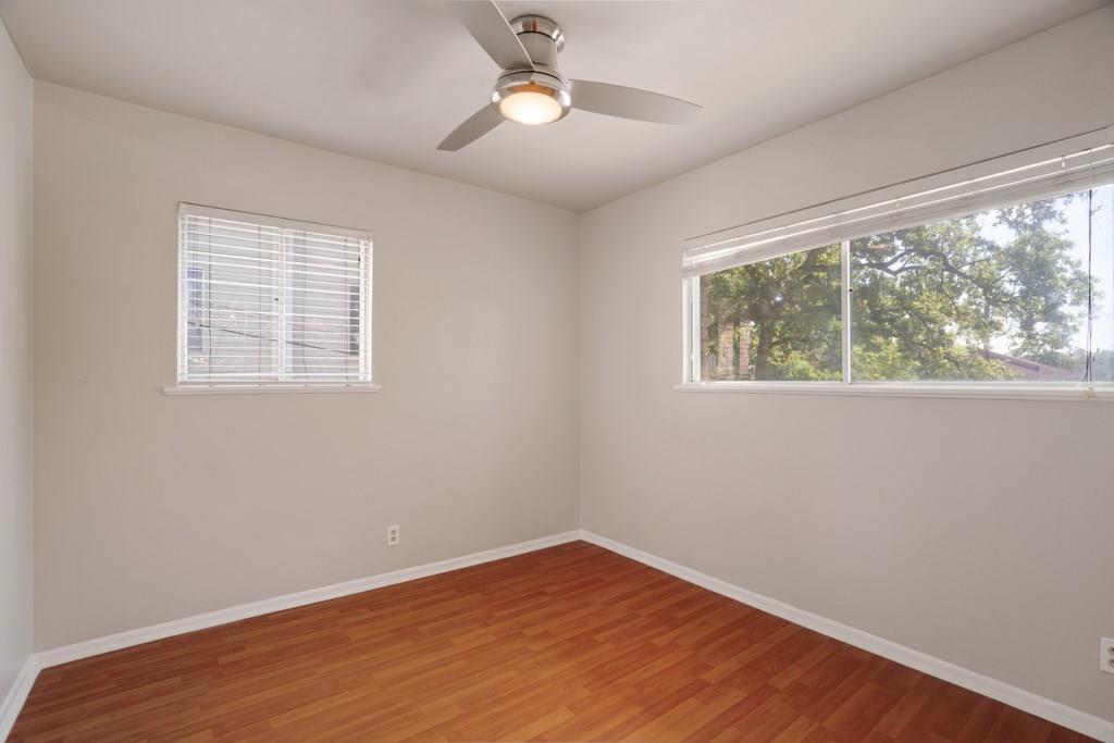 1311 Exposition Boulevard, Unit 8 Austin, TX 78703 - Photo 7 of 10 Spare room featuring wood finished floors and ceiling fan