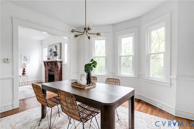 a dining room with furniture window and wooden floor