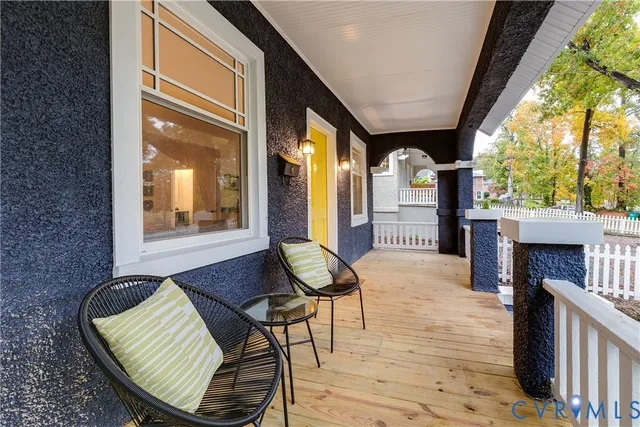 a balcony with furniture and a fireplace