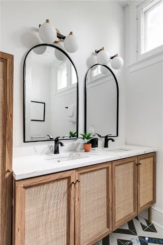 a bathroom with a double vanity sink and a mirror