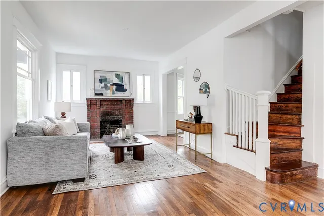 a living room with furniture and a fireplace