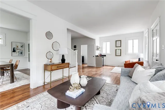 a living room with furniture and wooden floor