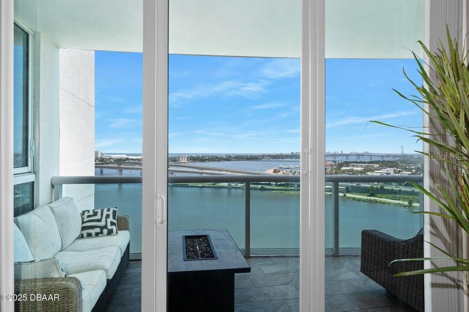 231 Riverside Drive, Unit 15071 Daytona Beach, FL 32117 - Photo 12 of 53 a living room with furniture and a floor to ceiling window