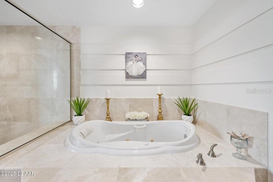 231 Riverside Drive, Unit 15071 Daytona Beach, FL 32117 - Photo 26 of 53 a white bath tub sitting in a bathroom